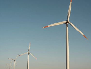 Wide landscape shot of a North American industrial wind farm. The massive turbines stand as a testament to sustainable and advanced mechanical engineering solutions.