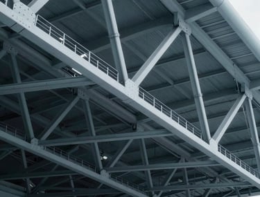Clean, technical rendering of a steel roof truss system for a stadium. The image is rendered with steel blue-grey tones, emphasizing geometric perfection and advanced modeling.