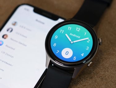 A close-up of an Android watch and phone synchronized. The interface is simple and useful. North American / US setting with a shallow depth of field.