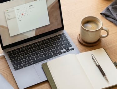 Clean workspace with laptop, notebook, and coffee representing starting a beauty business journey