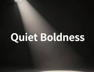 A cinematic high-contrast photograph of a light beam cutting through a dark studio, highlighting the concept of 'Quiet Boldness'.
