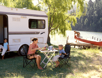 Camper by a lake with a canoe on a dock