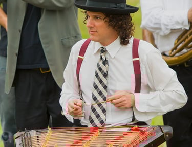 David Ansel playing tsimbl during a Mazel Tov Kocktail Hour show