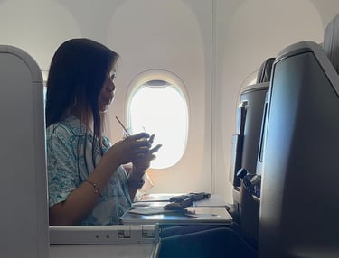 a lady drinking on a business class suite on singapore airlines