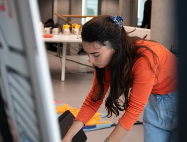 Sofia is painting a canvas for a live art performance. Photo by Emmanuelle Dekkers