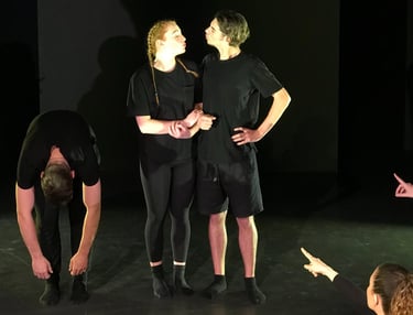 a group of people standing around a man in a black shirt