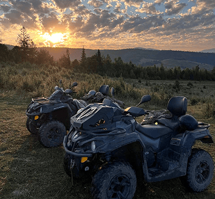 a couple of atvs parked in a field