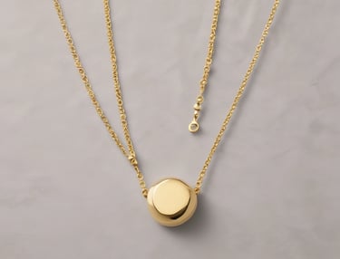 Elegant gold necklace with a small pendant displayed on a black bust.
