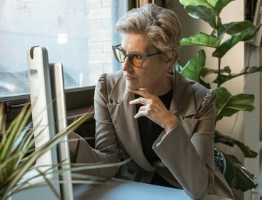 Female working professional looking at computer screen in a decorated office