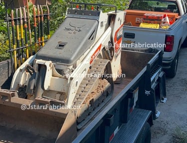 bobcat on top of a heavy duty trailer 