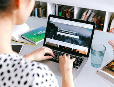 A woman sitting at a desk with a laptop computer
