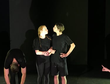 a group of people standing around a man in a black shirt