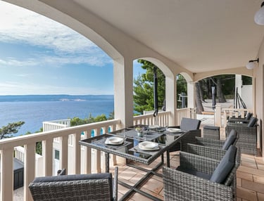 The photo shows an apartment balcony and a part of the pool. 