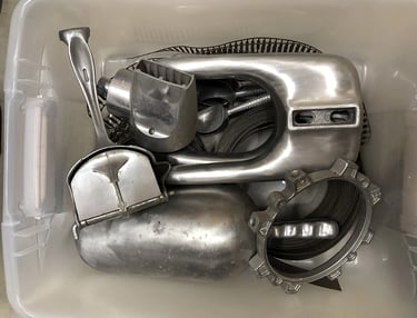 Metal parts in a sculptor's workshop bin, image 11.