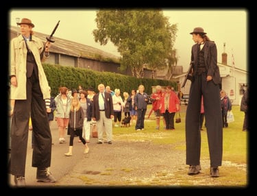 Two performers in in gangster suits on stilts speakeasy themed entertainment 