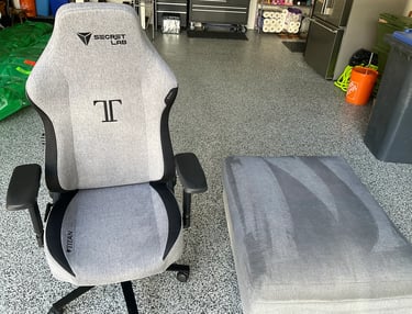 Finished result of our upholstery cleaning services on a chair and foot rest