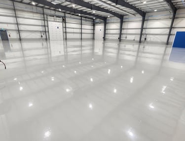 Industrial epoxy flooring system installed in a automotive garage environment