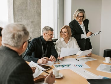 Group of advisors collaborating at a work table, consulting and sharing expertise