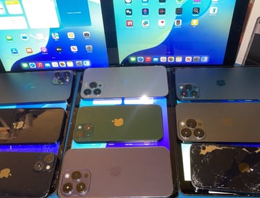 a group of 6 different colored iphones and ipads, broken and working devices 