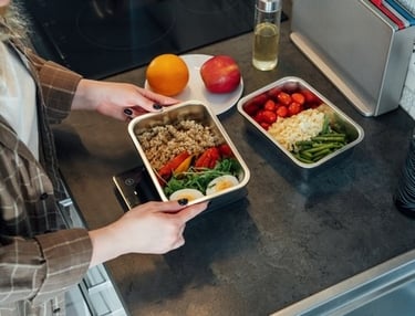 a woman is holding a tray with food in it