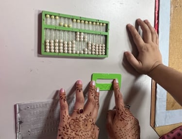 Image of two hands feelingtactile elements of study material for visually impaired