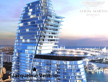 A luxury skyscraper with curved glass facade and the Aston Martin logo on top, located in Miami, Fl