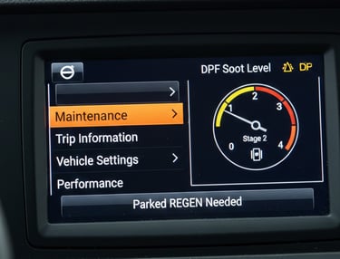 Close-up of Volvo FM Driver Information Display showing the Maintenance menu and DPF soot level gauge.