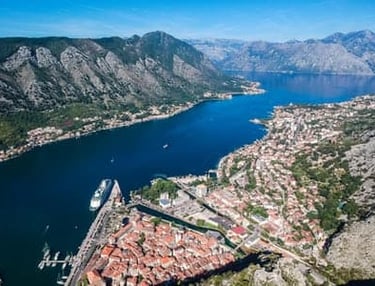 Aerial view of UNESCO World Heritage Kotor Old Town in Montenegro with cruise ship moored