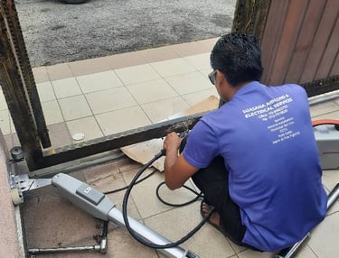 Suasana Security and Automations repairing automatic gate motor system.