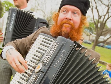 Dylan Blackthorn playing accordion during a live Mazel Tov Kocktail Hour show