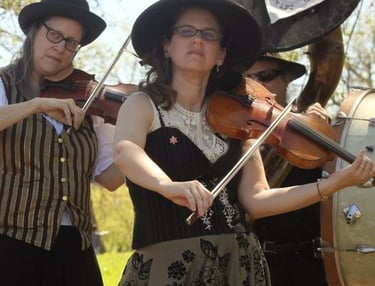 Jennifer Marshall playing violin during a Mazel Tov performance