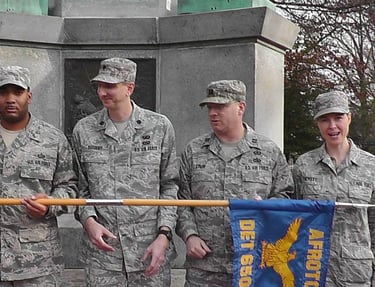 The Ohio University AFROTC cadre staff holding the unit flag, being silly. Cynthia  is on far right.