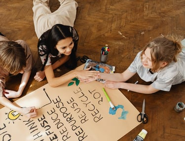 Photo by Photo By: Kaboompics.com: https://www.pexels.com/photo/friends-painting-on-brown-paper-7692