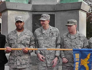 The Ohio University AFROTC cadre staff holding the unit flag, being silly. Cynthia is on far right.