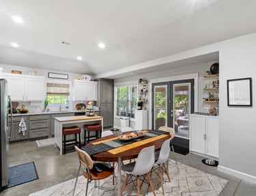 a kitchen with a table and chairs in the middle of the room