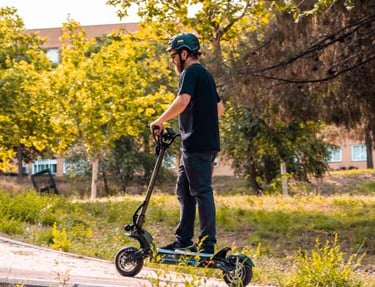 a man riding a scooter on a sidewalk