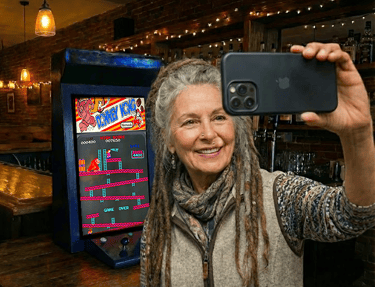 a Ashland lady taking a selfie showing their Donkey Kong High Score.