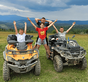 a group of people riding on four wheelers