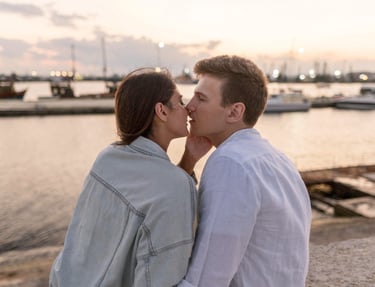 Sugar mommy and sugar baby sharing an intimate moment by the waterfront at dusk.