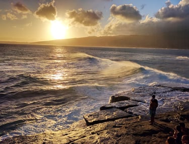 Photo of a person having a numinous experience before a sunset on the sea