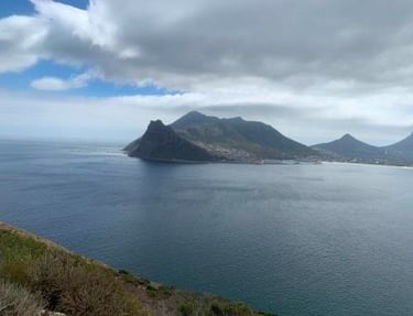a person sitting on a bench in the middle of a mountain
