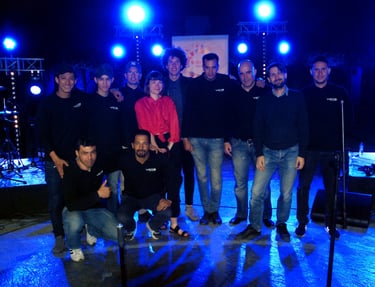 a group of people standing around a stage