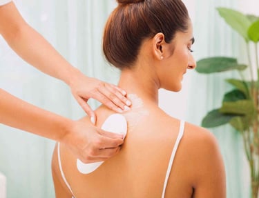 a woman is getting her full body waxed at a salon