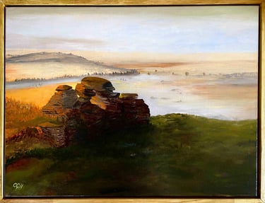 Oil painting of a misty sunrise over rocky tors and hills in a golden landscape.