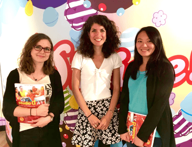 Linguages owner Linda with her German students at King in their London office, standing in front of a Candy Crush background