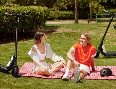 two people sitting on a blanket on a blanket