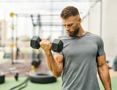 a young man curling a dumbbell