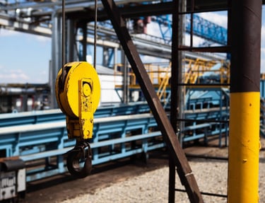 overhead crane hook, production plant in background