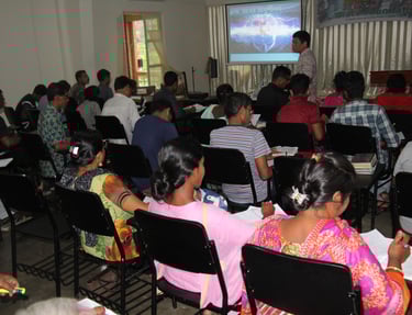 a group of people sitting in chairs in a room