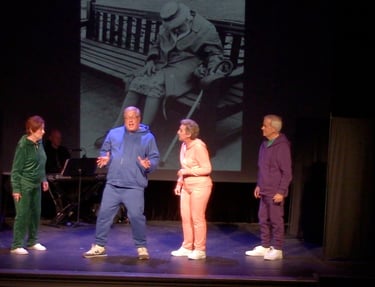 Senior actors performing a stage play in colorful tracksuits with a vintage photo backdrop.